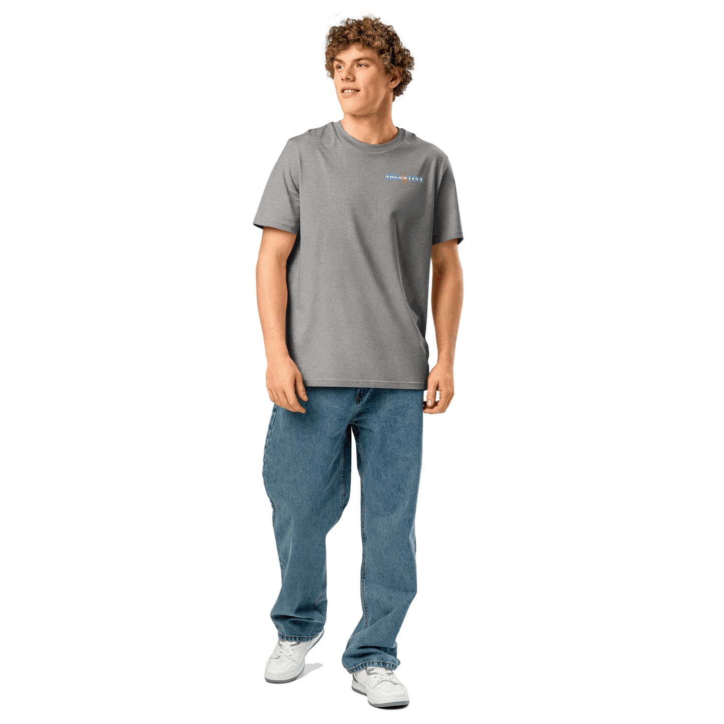 Man wearing grey Argentina Futbol Shirt with blue jeans and white sneakers, casual unisex fit tee made from organic cotton.